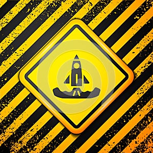 Black Rocket icon isolated on yellow background. Warning sign. Vector