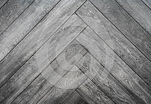 Black rough wooden background, parquet floor herringbone pattern