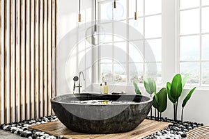 Black round bathtub in loft bathroom