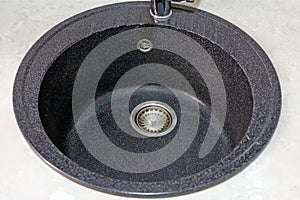 Black round granite sink for the kitchen top view.