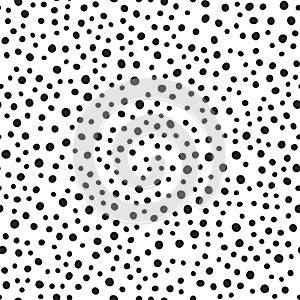 Black round spots scattered on white background. Seamless pattern. Irregular polka dot.