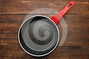 Black round teflon non-stick pan on table