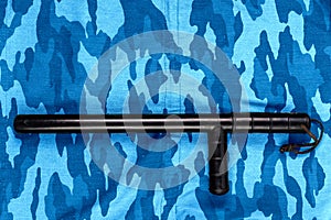 Black rubber baton on blue urban russian riot police camouflage flat lay