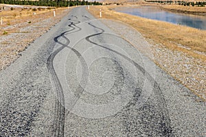 Black rubber tyre skid marks on tarmac road