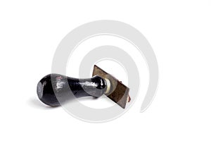 Black rubber wooden stamp placed on white background