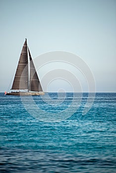 Black sailing yacht on the open sea