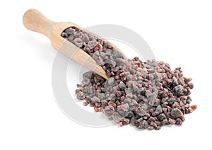 Black salt and wooden scoop on white background