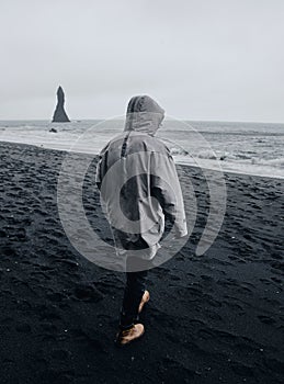 Black sand beach in Iceland. Man on blacksand