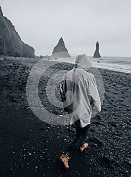 Black sand beach in Iceland. Man on blacksand photo