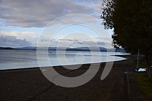 Black sand beach, near Mile Zero, The starting point of the Pan-American Way Hito Cero Chiloe, Chile photo