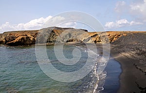 Black sand beach near a peninsula