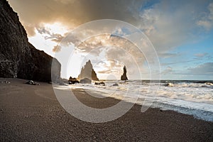 The black sand beach of Reynisfjara and basalt rock formations Troll toes in the southern coast of Iceland