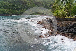 Black sand beach and rocks beside Arahoho Blowhole, Tahiti