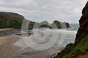 Black sand beach and rocky cliffs at Piha, New Zealand