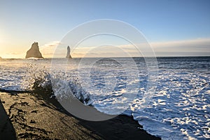 Black sand beach with Sneaker waves and sunrise