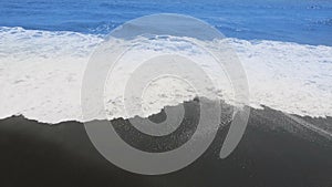 Black sand beach waves volcanic in Tenerife at Canary Islands