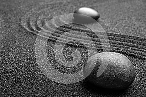 Black sand with stones and pattern. Zen concept