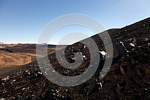 Black sand volcano mountain slope and lava remains in Iceland