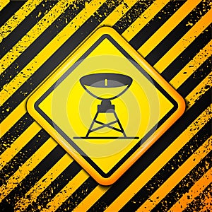 Black Satellite dish icon isolated on yellow background. Radio antenna, astronomy and space research. Warning sign