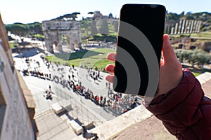 Black screen of a smartphone at he Colosseum in Rome
