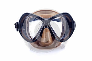 Black Scuba Diving Mask on Brown Mannequin Head Against White Background