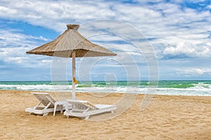 Black Sea beach with umbrellas, fine sand, cool water and blue s