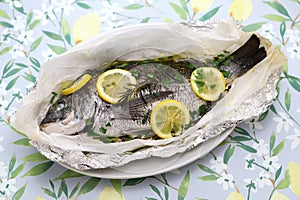 Black sea bream wrapped in paper and baked, Italian cuisine