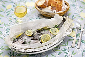 Black sea bream wrapped in paper and baked, Italian cuisine