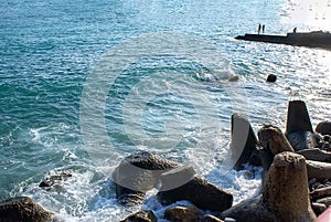 Black sea coast in Crimea with concrete breakwaters. Seascape. Black sea on a Sunny summer day.