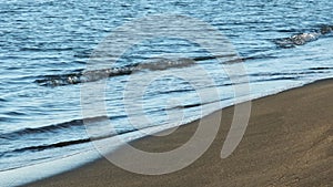 Black Sea coastline in Georgia Ureki, dark magnette balneotherapy sand and blue sea water waves, sunset beach coastline