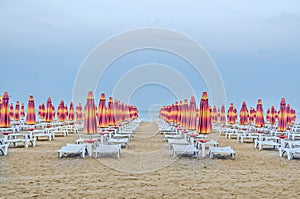 The Black Sea shore. blue sea water, clouds sunset sky, beach sand with umbrellas and sunbeds