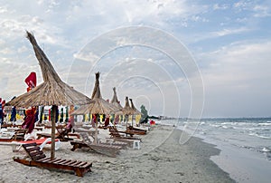 The Black Sea shore, sea side with sand, umbrellas, sun beds and water