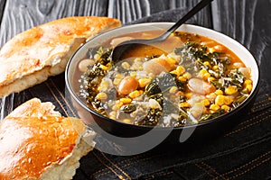 Black Sea Turkish vegetarian Kara lahana corbasÄ± spicy cabbage soup with kale, beans, tomatoes and corn close-up in a bowl.