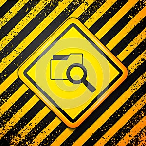 Black Search concept with folder icon isolated on yellow background. Magnifying glass and document. Data and information
