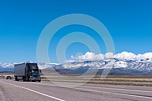 Black semi truck on the freeway