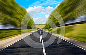 Black serpentine of asphalt road in sunny day.