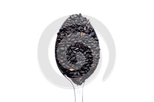 Black sesame seed in spoon on white background