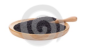 Black sesame seeds in wooden spoon isolated on white background