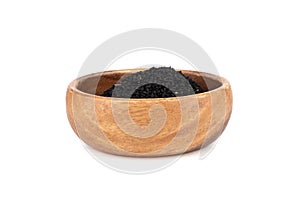 Black sesame in wooden bowl on white background.