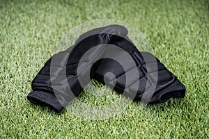 Black Shin Guards On Green Turf Background