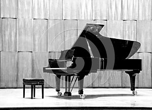 Grand piano set on stage, B&W