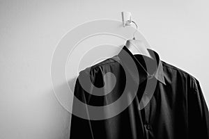 Black shirt with hanger on white background