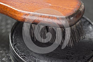 Black shoe shine wax and boot brush. Protecting and impregnate leather shoes