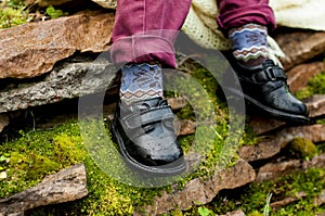 Black shoes with colored socks on child legs