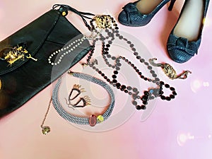 Black shoes on high heels and black leather clutch bag fashion pink leather handbag and summer stylish shoes living coral jewelry