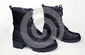 Black shoes with laces on a white background. Isolate.Black army shoes isolated on a white background. Black army shoes