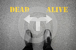 Black shoes standing at the crossroad - dead or alive