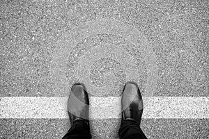 Black shoes standing on white line