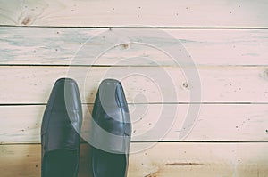 Black shoes on wooden background. Top view.