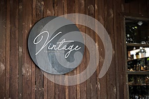 Black sign on a wooden wall mockup photo
